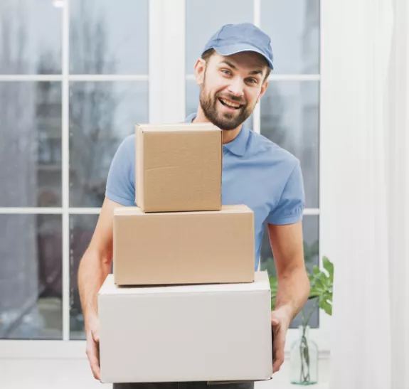 Mover holding stacked cardboard boxes